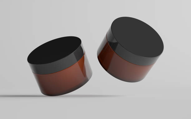 istock Amber Glass Cosmetic Jar Mockup - Two Jars 1311546743