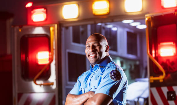 istock Paramedic in front of ambulance 1311547619