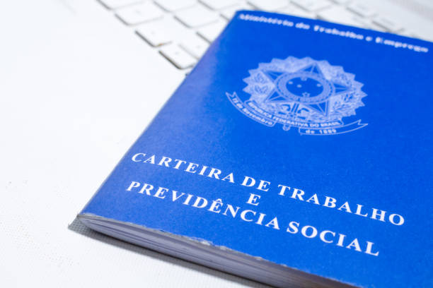 istock Brazilian work card over white laptop keyboard. Digital work document. 1311555662