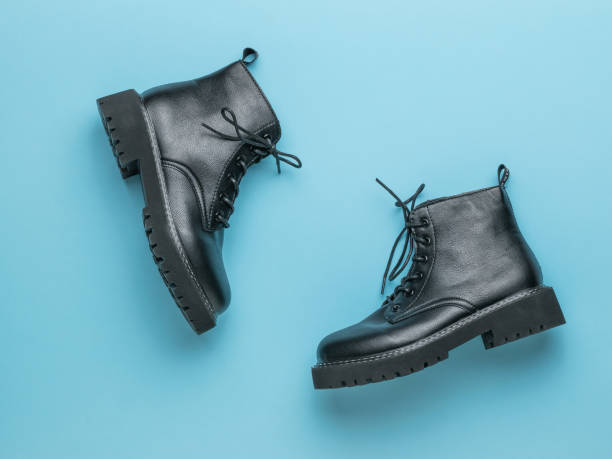 istock Brutal leather shoes with laces on a blue background. 1311561914