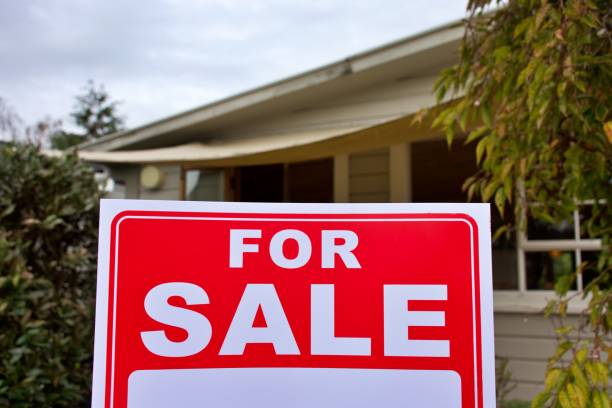 istock For Sale Sign Outside House 1311562847