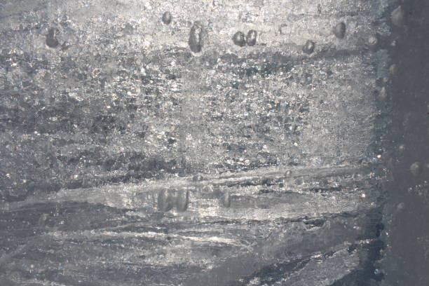 istock frozen air bubbles in the thickness of transparent ice background 1311562903