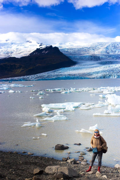 istock Glacier Lagoon, Iceland: Woman at Waterfront 1311562971