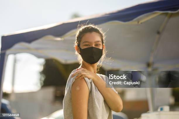 Teen Girl After Her Vaccination Stock Photo - Download Image Now - Vaccination, Teenager, COVID-19 Vaccine