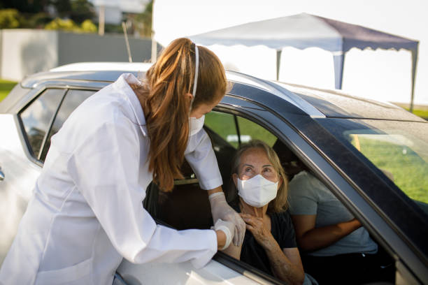 istock Senior woman being vaccinated in car 1311564470