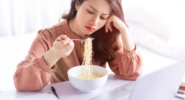 Business woman Asian businesswoman has to eat noodles while working drudgery photos stock pictures, royalty-free photos & images