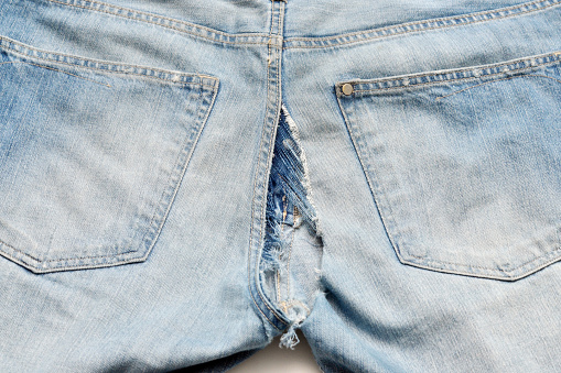 Closeup of split jeans.