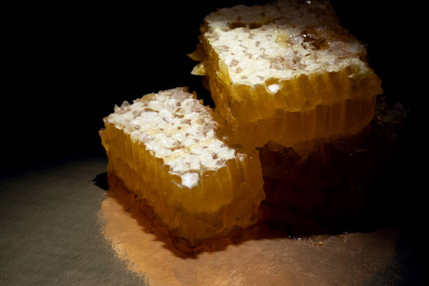 istock fresh closed honeycomb covered with wax on dark background. 1311571747
