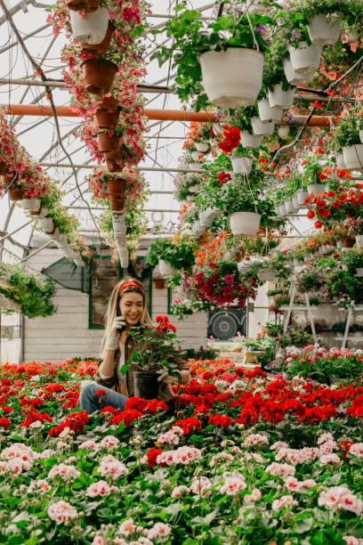 istock Happy florist worker talking on the phone 1311573439