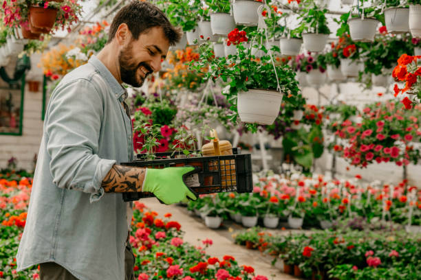 istock Side view of a smiling plant nursery worker 1311574285