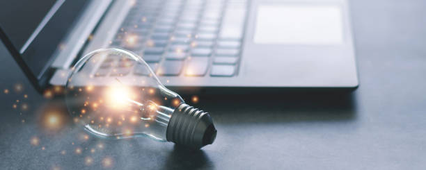 laptop and glowing light bulb. self learning or education knowledge and business studying concept. idea of learning online or e-learning from home. - inspiração imagens e fotografias de stock