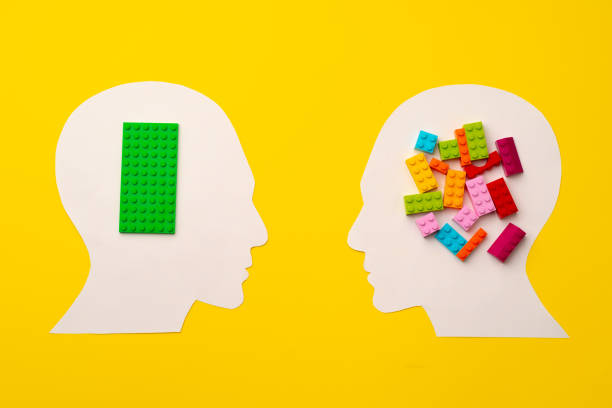 istock Papercut head silhouette with toy constructor pieces on yellow background 1311581205