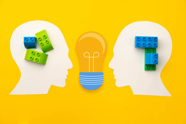 istock Papercut head silhouette with toy constructor pieces on yellow background 1311581262