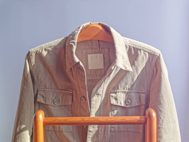 Unisex basic clothing for the spring or fall season, in cool weather. A khaki denim jacket is on the wooden shoulders.