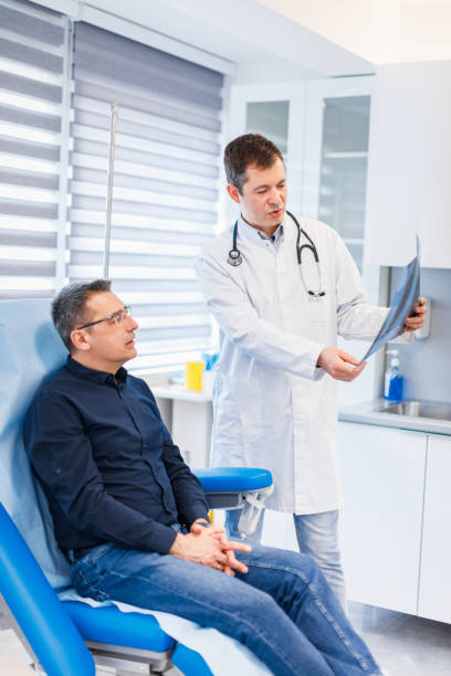 istock Radiologist explains to patient a lung X-ray image 1311584074