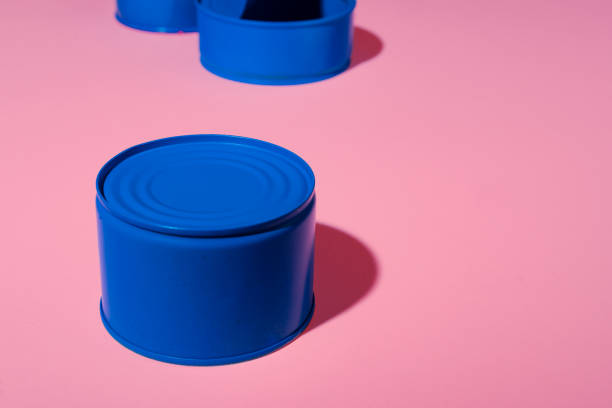 istock Aesthetic concept with blue painted tin can on pink background 1311586979