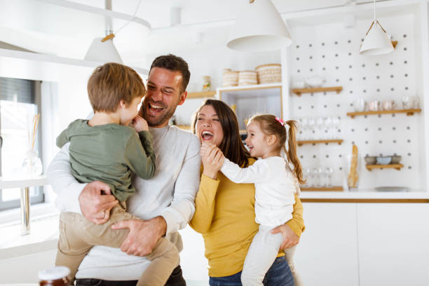 istock Cheerful parents having fun with their kids at home. 1311587875