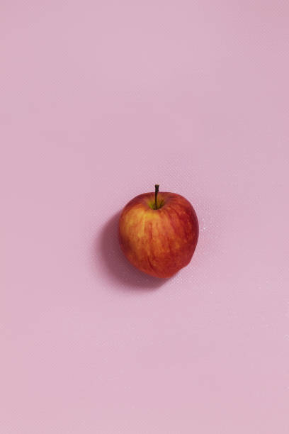 istock In the center on a pink background is a fresh red apple 1311588022