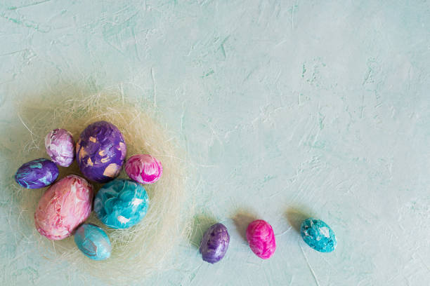 istock Happy Easter. Easter colorful eggs on a mint wooden background. 1311590205