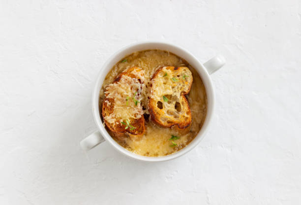 french onion soup with toasts and cheese. french cuisine. vegetarian food. - portion cheese baguette bread imagens e fotografias de stock