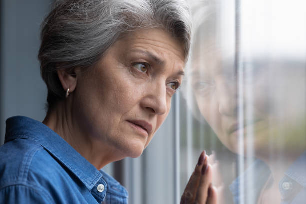 istock Depressed elderly hispanic lady widow mourning for gone husband 1311594962