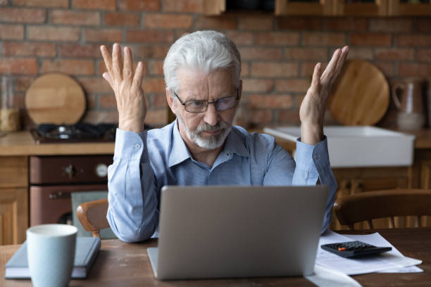 Stressed old grandpa confused with unexpected debt on pc screen Annoyed worried aged man pensioner sit by laptop unable to make utility bill loan payment online has question how to use app need help. Stressed old grandpa confused with unexpected debt on pc screen operating budget stock pictures, royalty-free photos & images