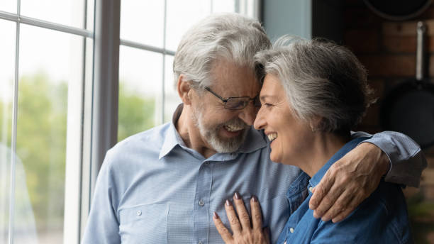 istock Affectionate loving retired couple have date laugh cuddle touch foreheads 1311594978