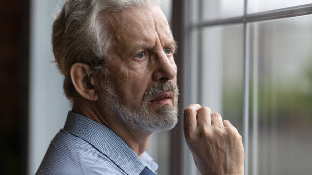 istock Worried nervous elderly man look at window wait for someone 1311594999