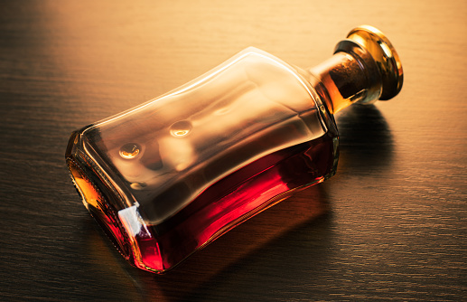 alcoholic drink, bottle of whiskey on wooden background