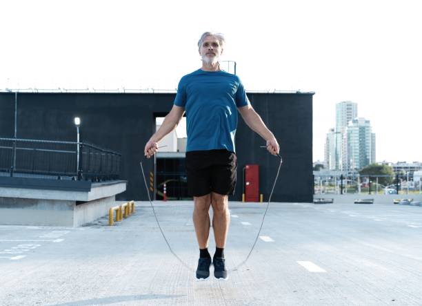 istock Middle-aged man exercising with jump-rope outdoors. 1311596648