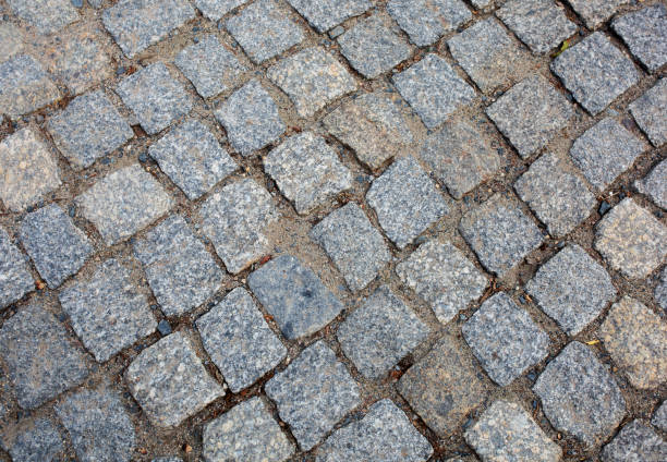 istock Old pedestrian road paved with granite stones 1311597070
