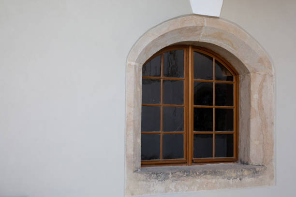 istock Vintage arched wooden window outside room 1311597099