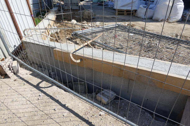 istock Construction of a cinder block wall surrounding a building 1311600232