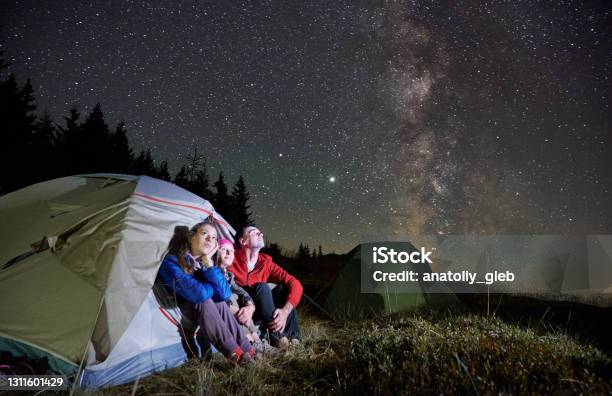 Travelers Sitting In Camp Tent Under Night Starry Sky Stock Photo - Download Image Now