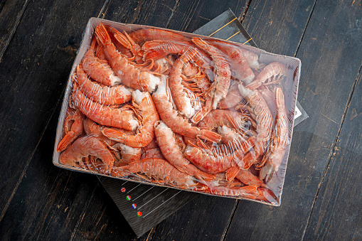 Large frozen headless langoustine prawns in a package. Seafood healthy.