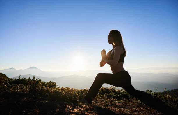 istock Young woman doing yoga exercise on fresh air. 1311601788