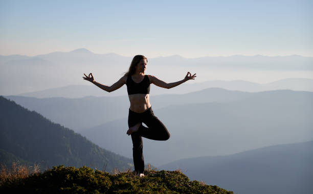 istock Woman is practicing yoga in mountains. 1311601804