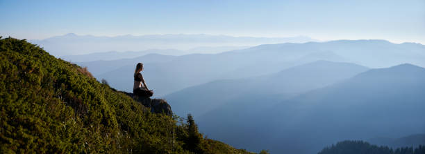 istock Meditating female is relaxing on in mountains. 1311601828