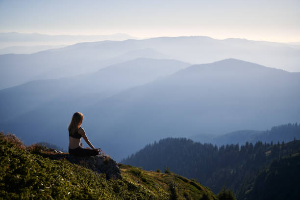 istock Young woman doing meditation on fresh air. 1311601833