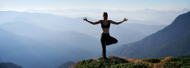 istock Fit young woman doing yoga pose in mountains. 1311601838