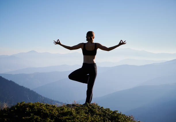 istock Female is balancing on one leg in mountains. 1311601839
