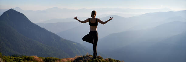 istock Fit young woman doing yoga pose in mountains. 1311601842