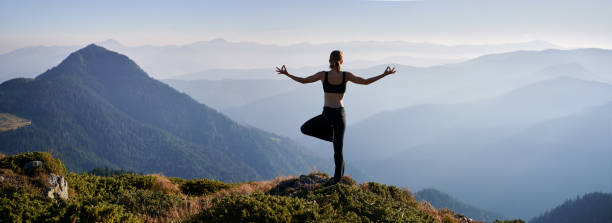 istock Woman is practicing yoga in evening mountains. 1311601847
