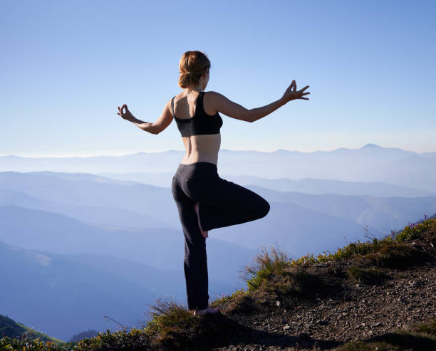 istock Slim woman standing in pose yoga on nature. 1311601848