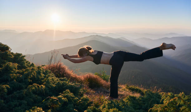 istock Woman is practicing yoga in fly pose outdoor. 1311601859