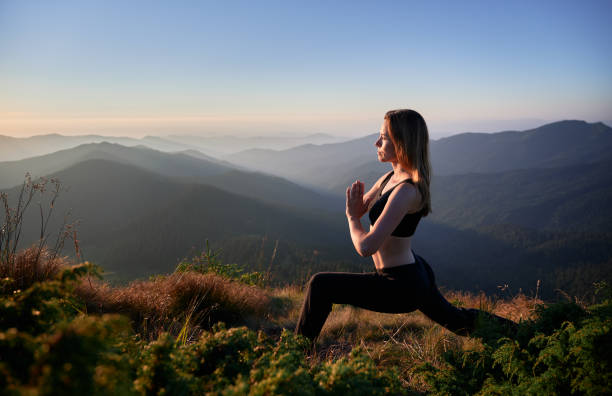 istock Beautiful woman doing exercise yoga in mountains. 1311601870