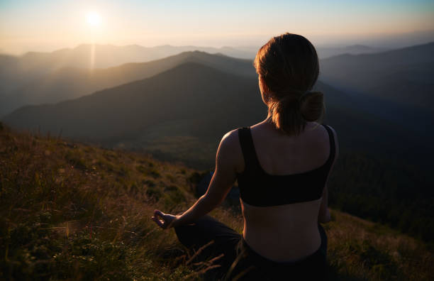 istock Slender woman doing yoga on fresh air. 1311601890