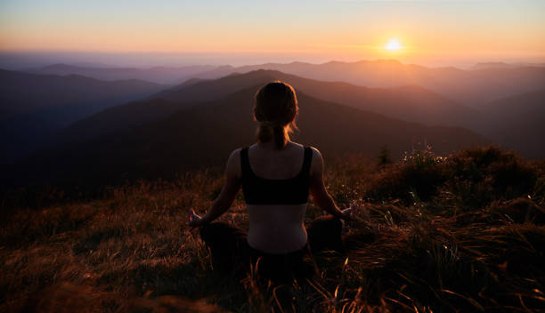 istock Meditating female is relaxing in mountains. 1311601905