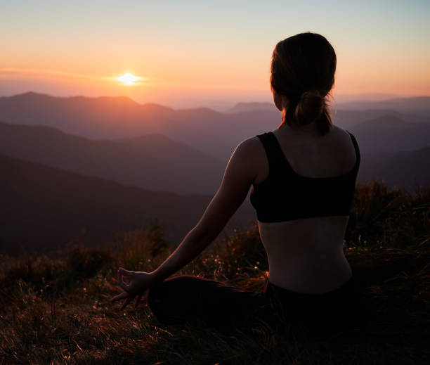 istock Young woman doing meditation on fresh air. 1311601907