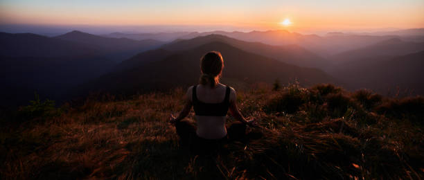 istock Meditating female is relaxing in mountains. 1311601918